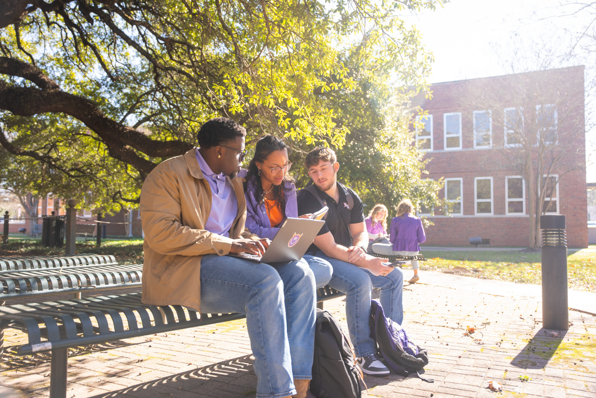Northwestern students sitting together on a campus bench, reflecting and collaborating