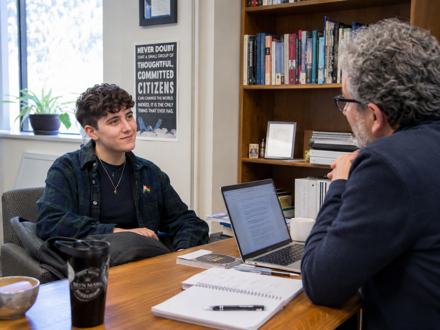 A Northwestern student and professor talking together in an office
